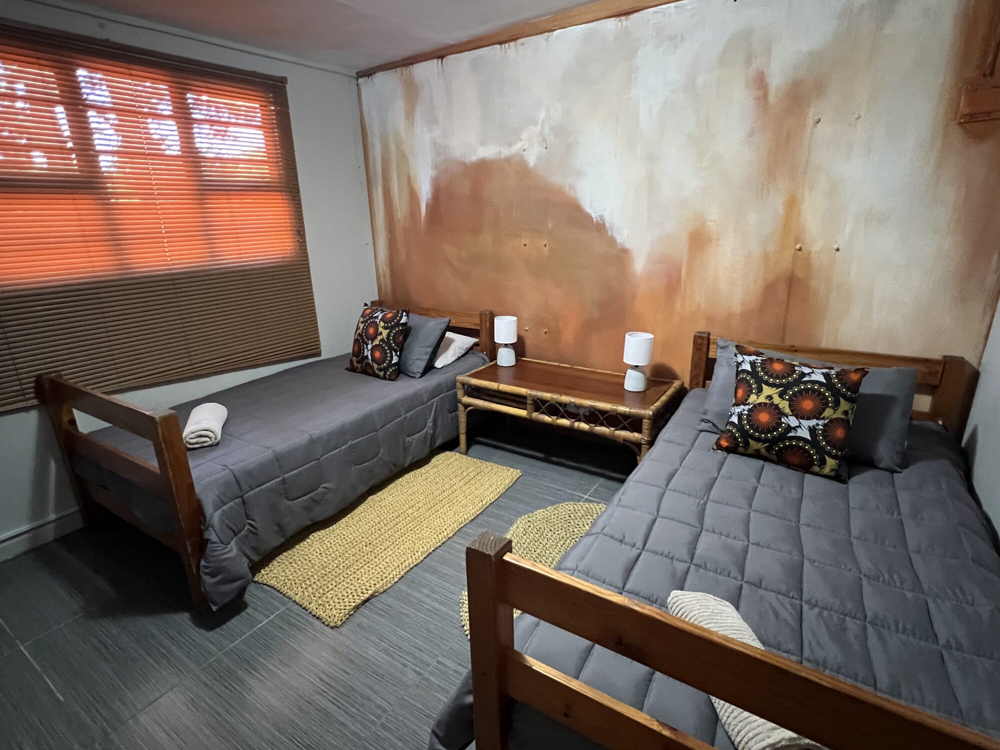 Twin bedroom with copper-toned feature wall