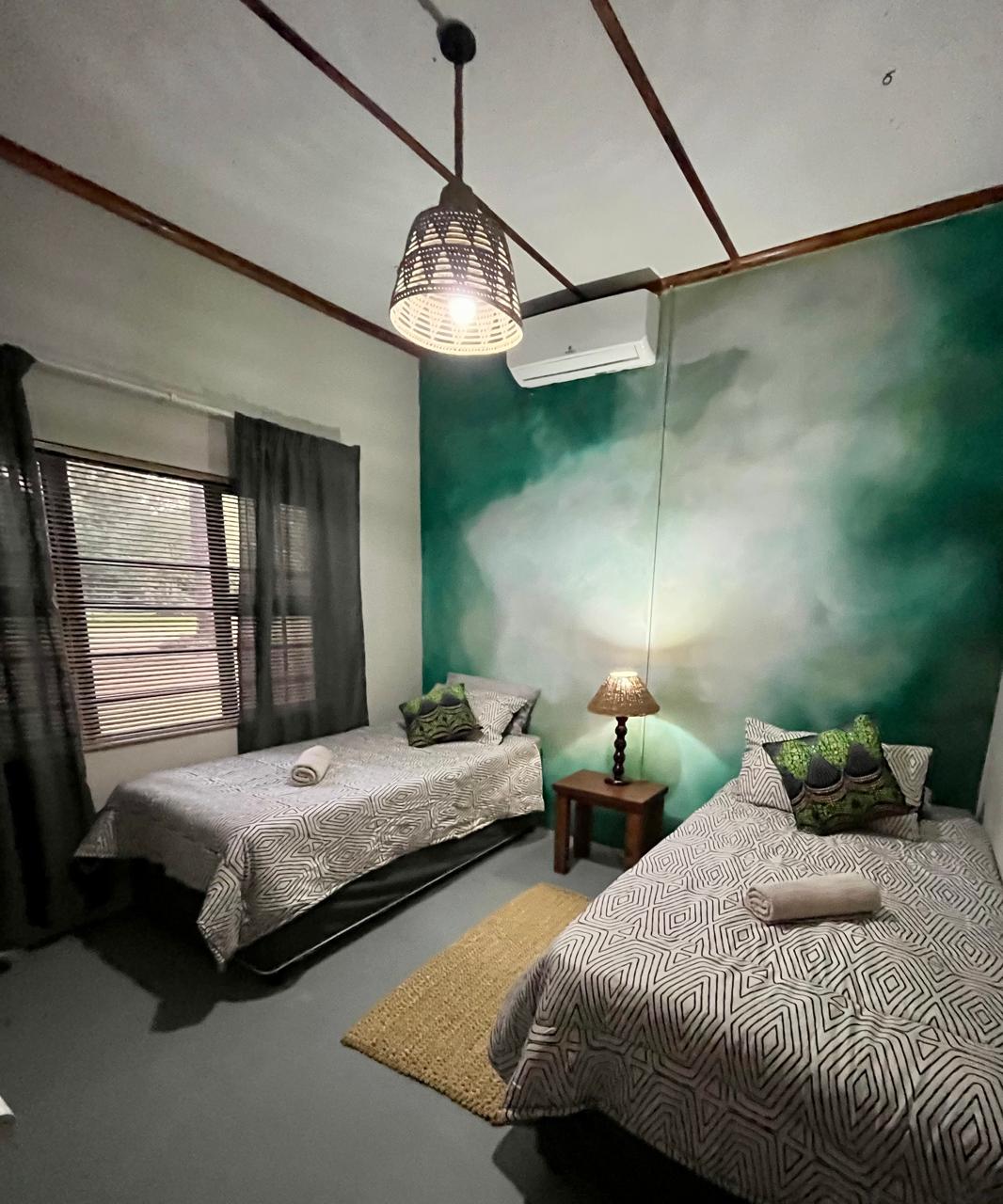 Lounge with botanical mural and plaid sofas