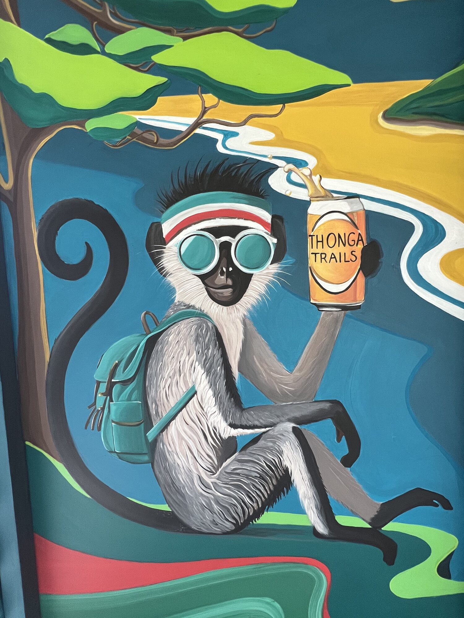 Mural of a vervet monkey holding a Thonga Trails can