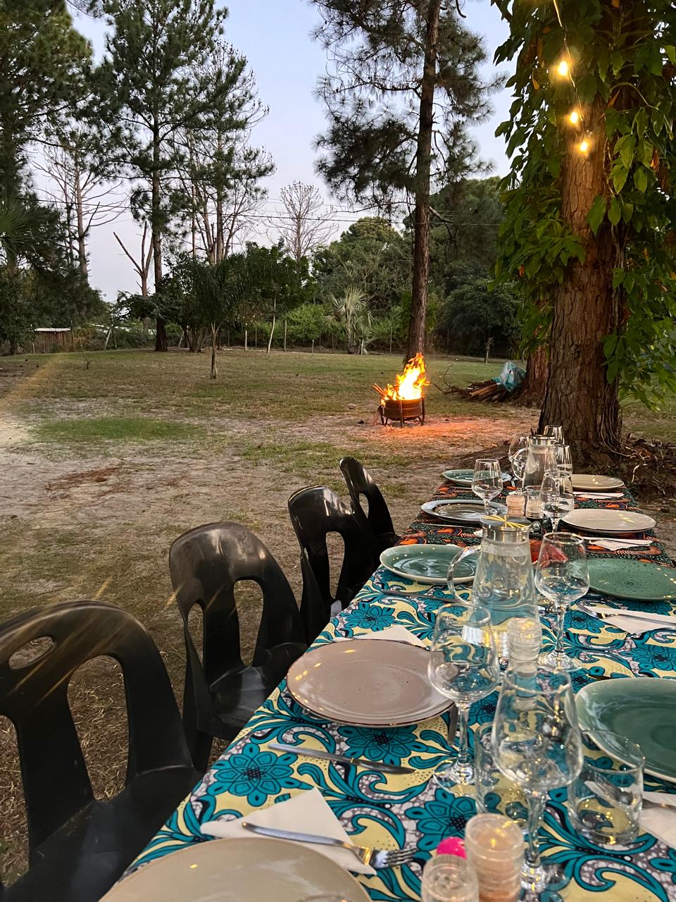 Wood-fired pizza oven and outdoor dining at dusk