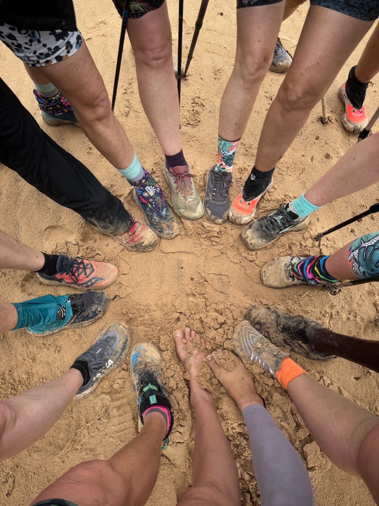 Hikers' feet in a circle on the sand after a Thonga trail day